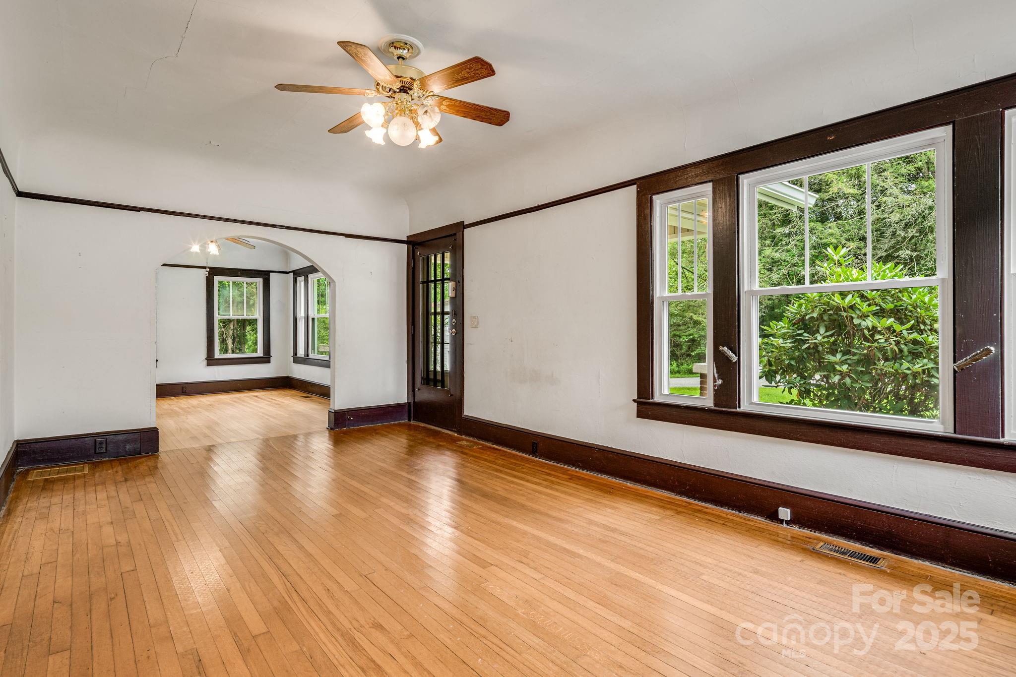 206 Rhododendron Drive Brevard, NC 28712 - Photo 10 of 36 a view of an empty room with window and wooden floor