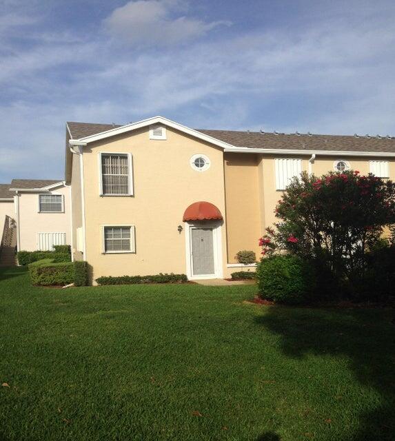 423 Waterside Circle Lake Worth, FL 33462 - Photo 1 of 21 a front view of a house with a garden