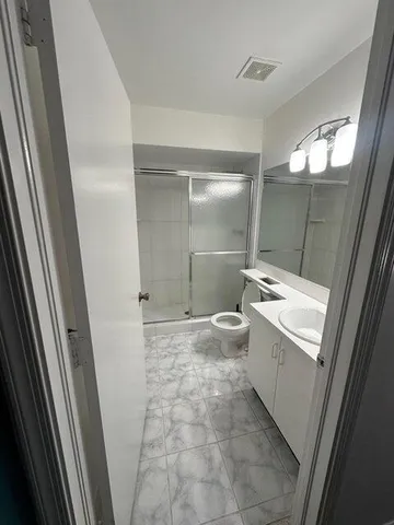 a bathroom with a sink toilet and shower