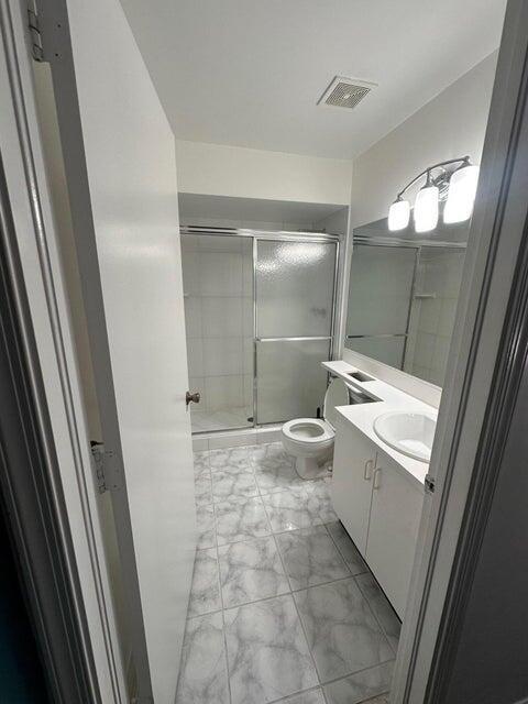 423 Waterside Circle Lake Worth, FL 33462 - Photo 15 of 21 a bathroom with a sink a toilet and mirror