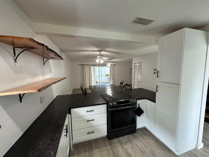 423 Waterside Circle Lake Worth, FL 33462 - Photo 6 of 21 a bedroom with a bed and a dresser