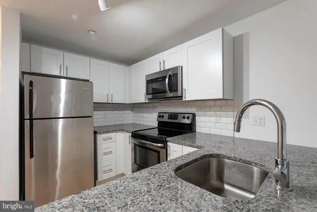 a kitchen with a refrigerator sink and microwave