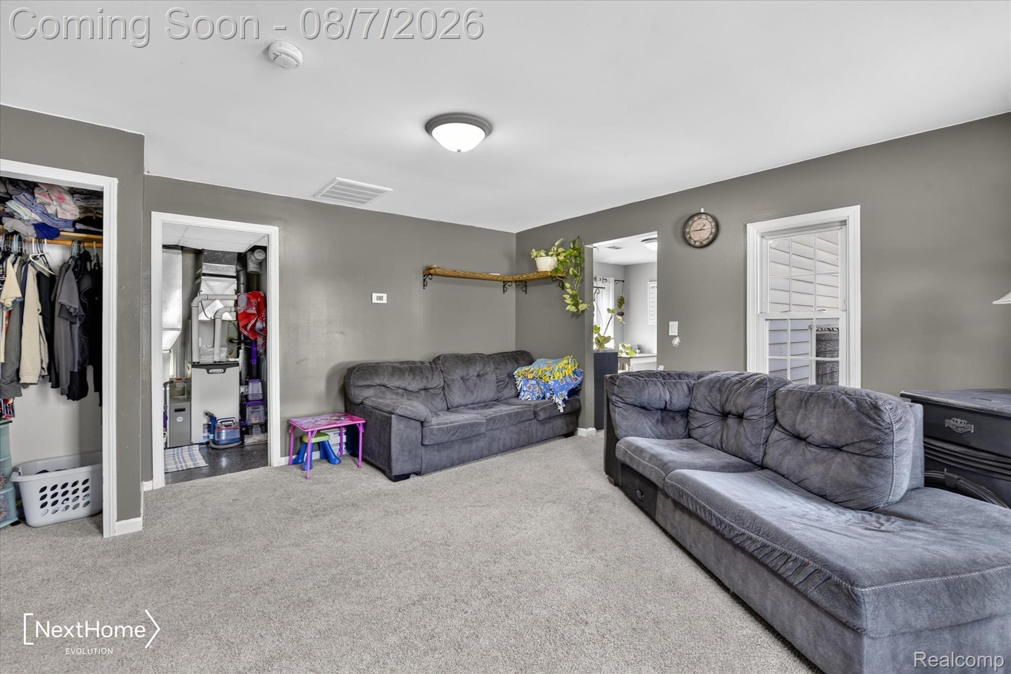 23740 Carleton West Road Belleville, MI 48111 - Photo 11 of 58 Spacious bonus room featuring plush seating arrangements, neutral carpet flooring, and abundant natural light from multiple windows