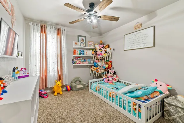 a bedroom with furniture a baby bed and a window