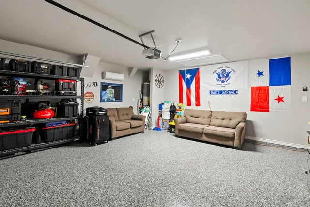 a living room with furniture a couch and a ceiling fan