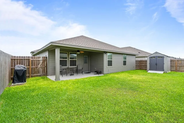 a view of a house with a backyard and a garden