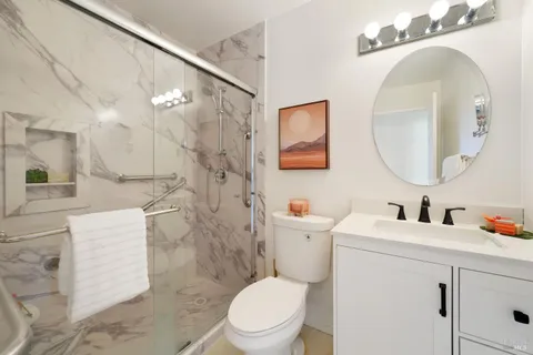 a bathroom with a toilet sink and mirror