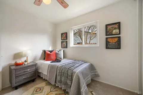 a bedroom with a bed and painting on the wall