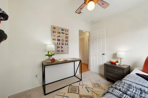a bedroom with a bed and a chandelier