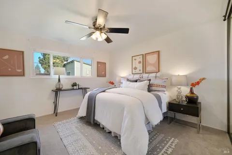 a spacious bedroom with a bed and window