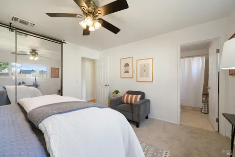 a bedroom with a bed and ceiling fan