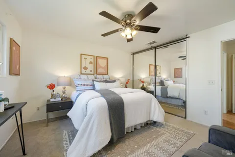 a spacious bedroom with a bed and a chandelier