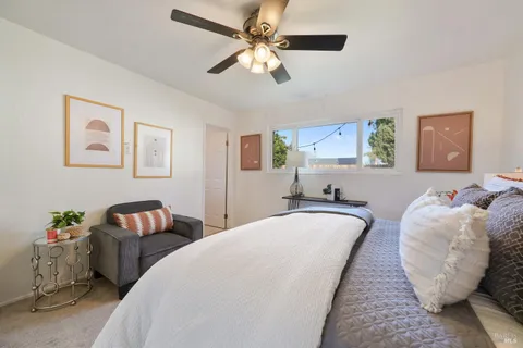 a spacious bedroom with two bed and a chandelier