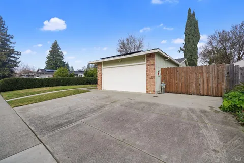 a view of a house with a yard and garage