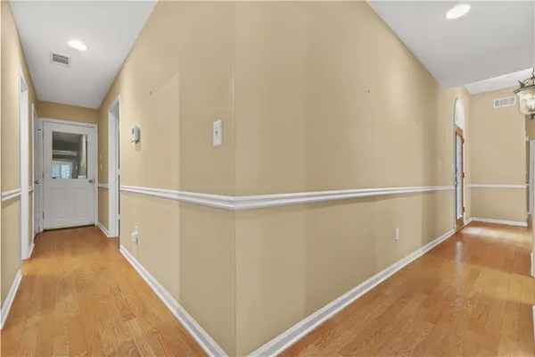 an empty room with windows and cabinet