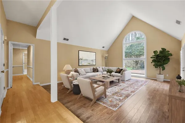a living room with furniture and kitchen view