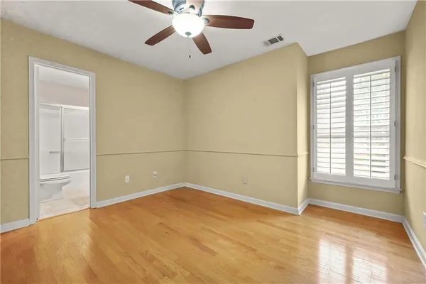 a view of empty room with ceiling fan