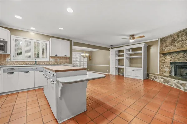 a large kitchen with cabinets and wooden floor