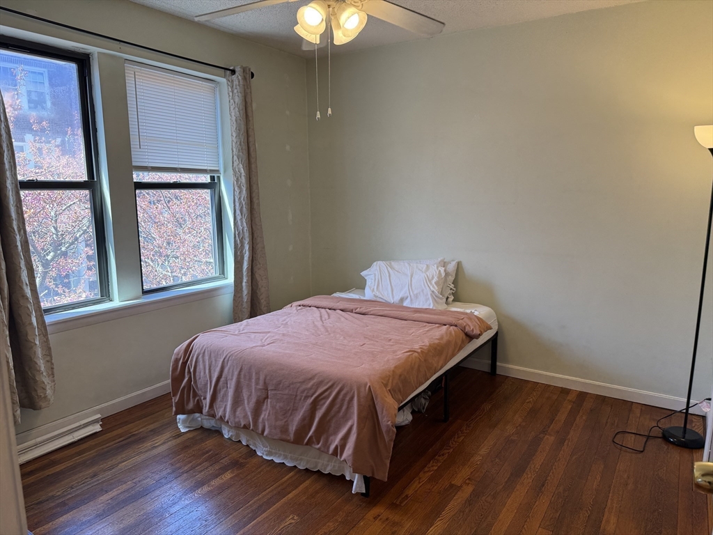 313 Summit Avenue, Unit 5 Boston, MA 02135 - Photo 4 of 13 a bedroom with a bed and a window