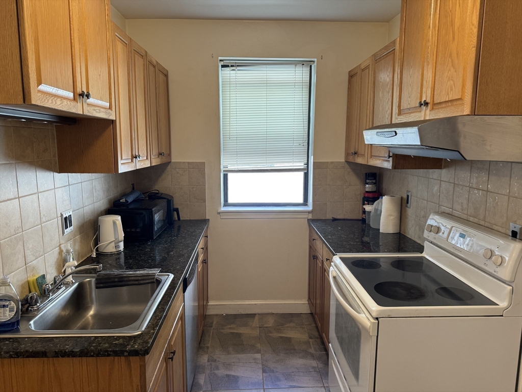 313 Summit Avenue, Unit 5 Boston, MA 02135 - Photo 7 of 13 a kitchen that has a sink and a stove