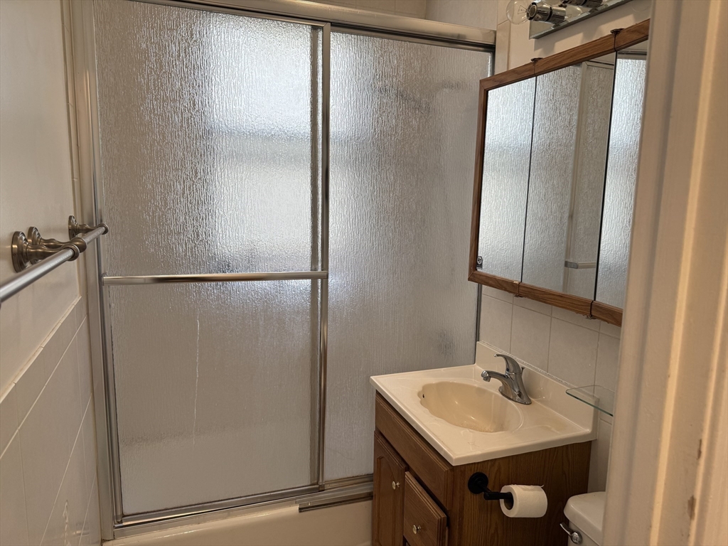 313 Summit Avenue, Unit 5 Boston, MA 02135 - Photo 9 of 13 a bathroom with a sink and mirror