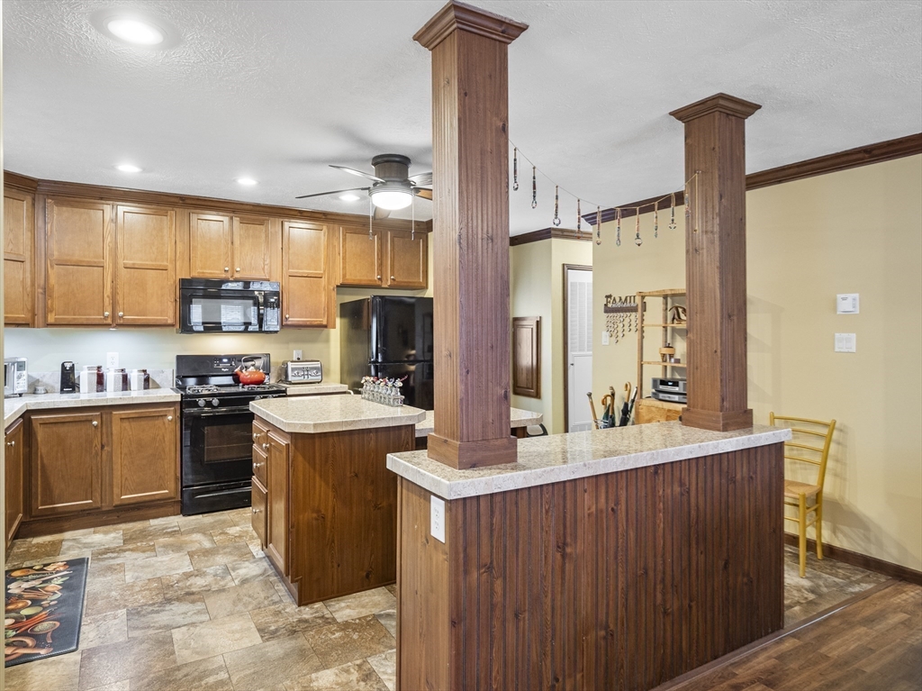 53 Ruby Road Gardner, MA 01440 - Photo 24 of 40 a kitchen with kitchen island a sink a counter top space and stainless steel appliances