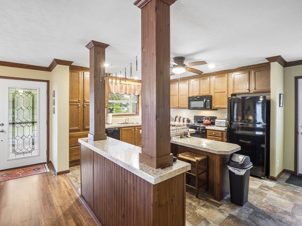 53 Ruby Road Gardner, MA 01440 - Photo 8 of 40 a kitchen with a refrigerator a sink dishwasher with a dining table and chairs