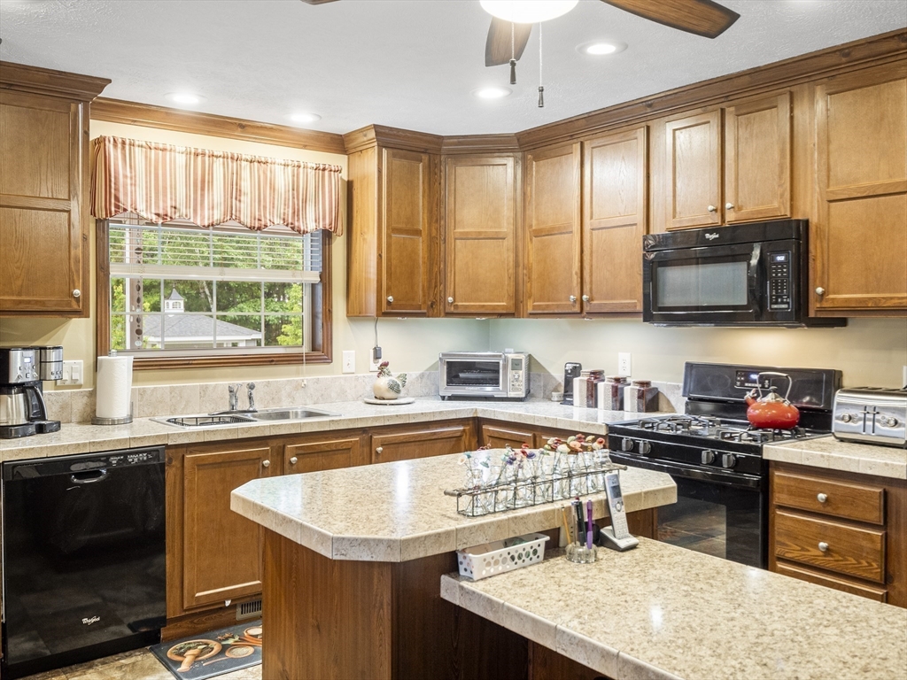 53 Ruby Road Gardner, MA 01440 - Photo 10 of 40 a kitchen with a sink a stove and a microwave