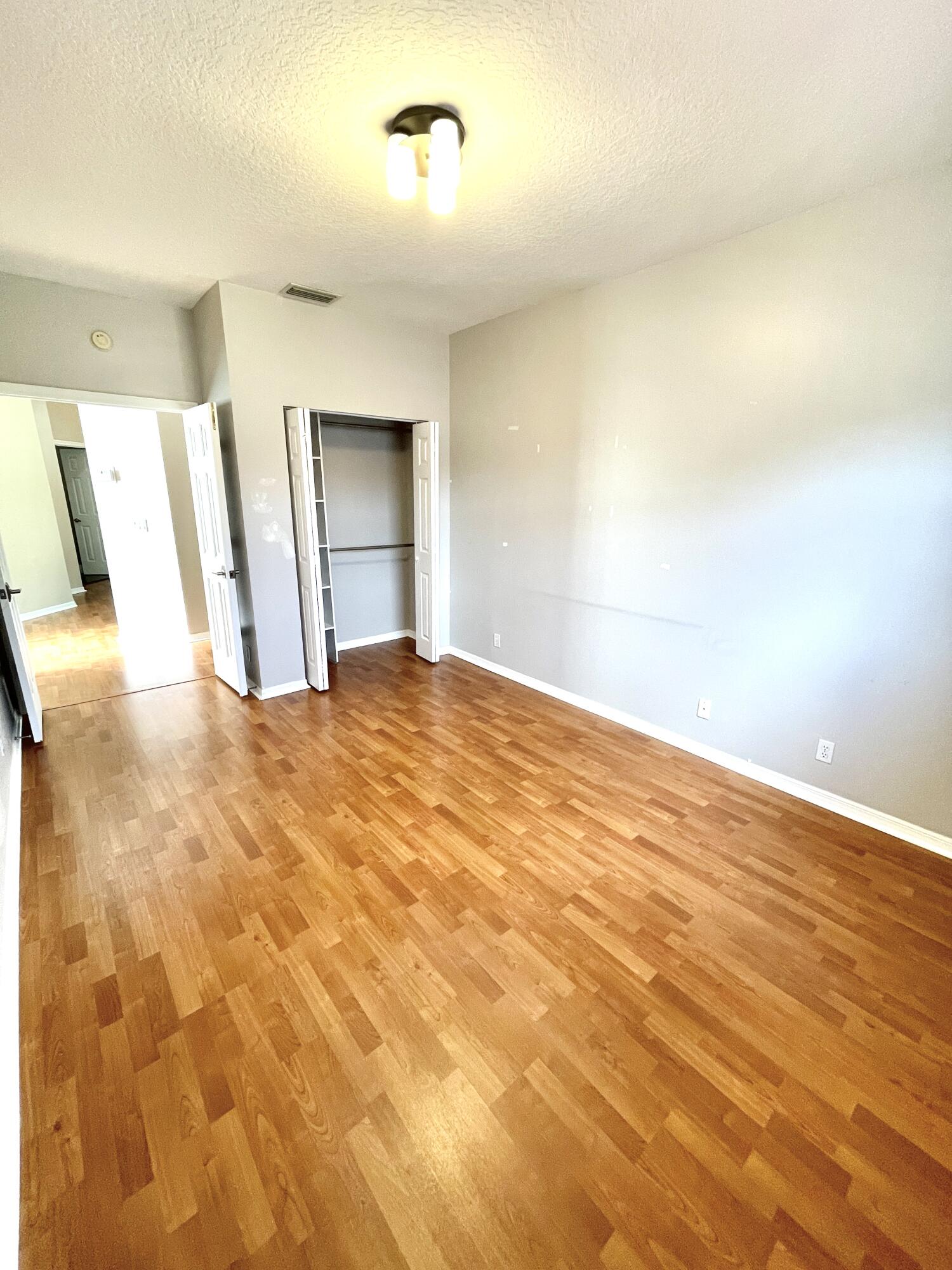 8550 Vía Romana, Unit 2 Boca Raton, FL 33496 - Photo 20 of 28 a view of empty room with wooden floor