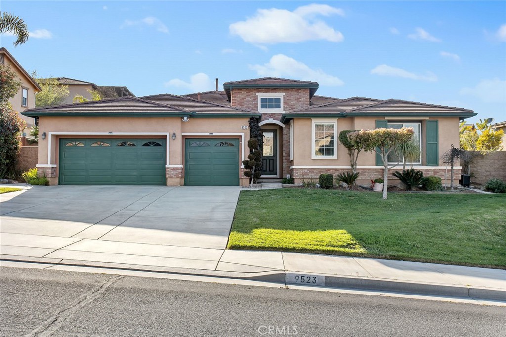 a front view of a house with a yard and garage
