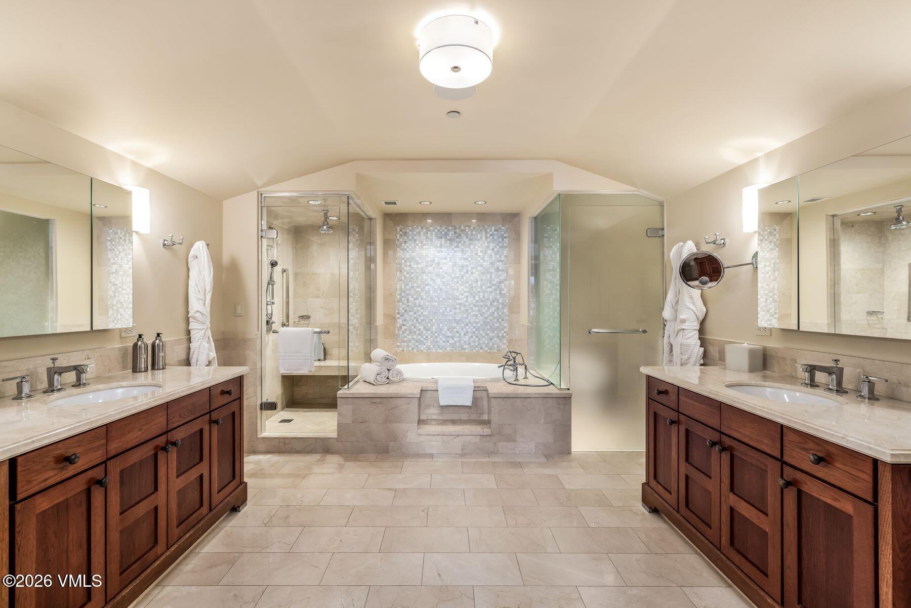 1 Vail Road, Unit 9204 Vail, CO 81657 - Photo 16 of 27 a spacious bathroom with a double vanity sink mirror double and bathtub