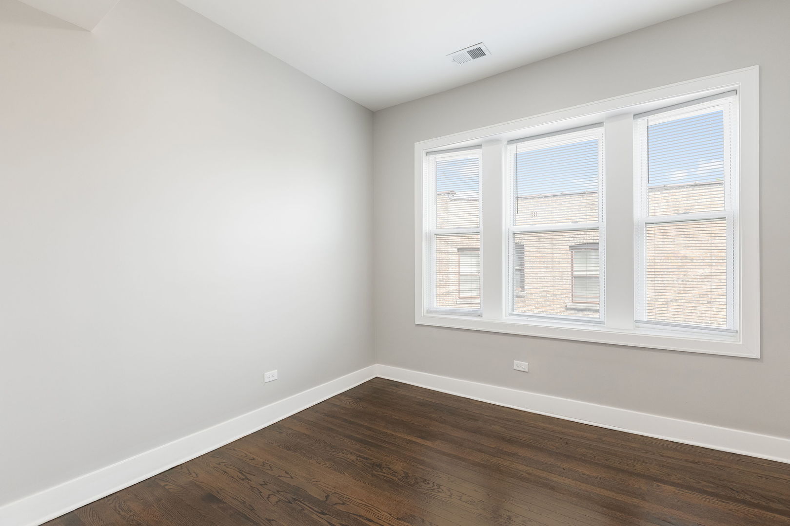7753 South Morgan Street, Unit 3 Chicago, IL 60620 - Photo 11 of 13 an empty room with wooden floor and windows