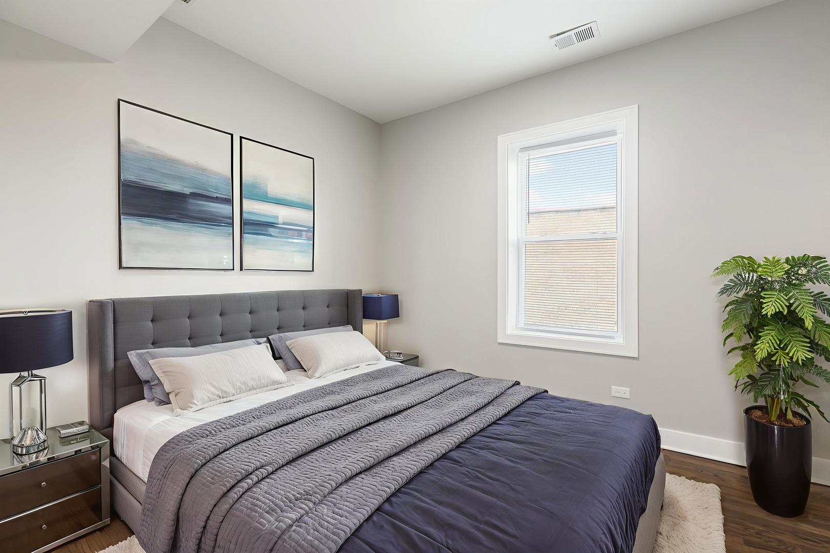 7753 South Morgan Street, Unit 3 Chicago, IL 60620 - Photo 7 of 13 a bedroom with a bed and a potted plant