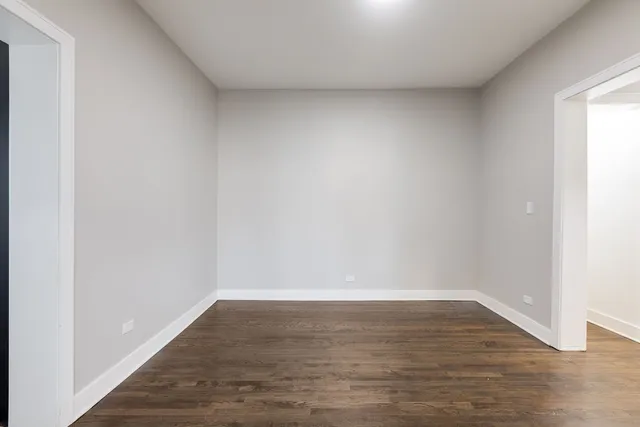 a view of an empty room and wooden floor