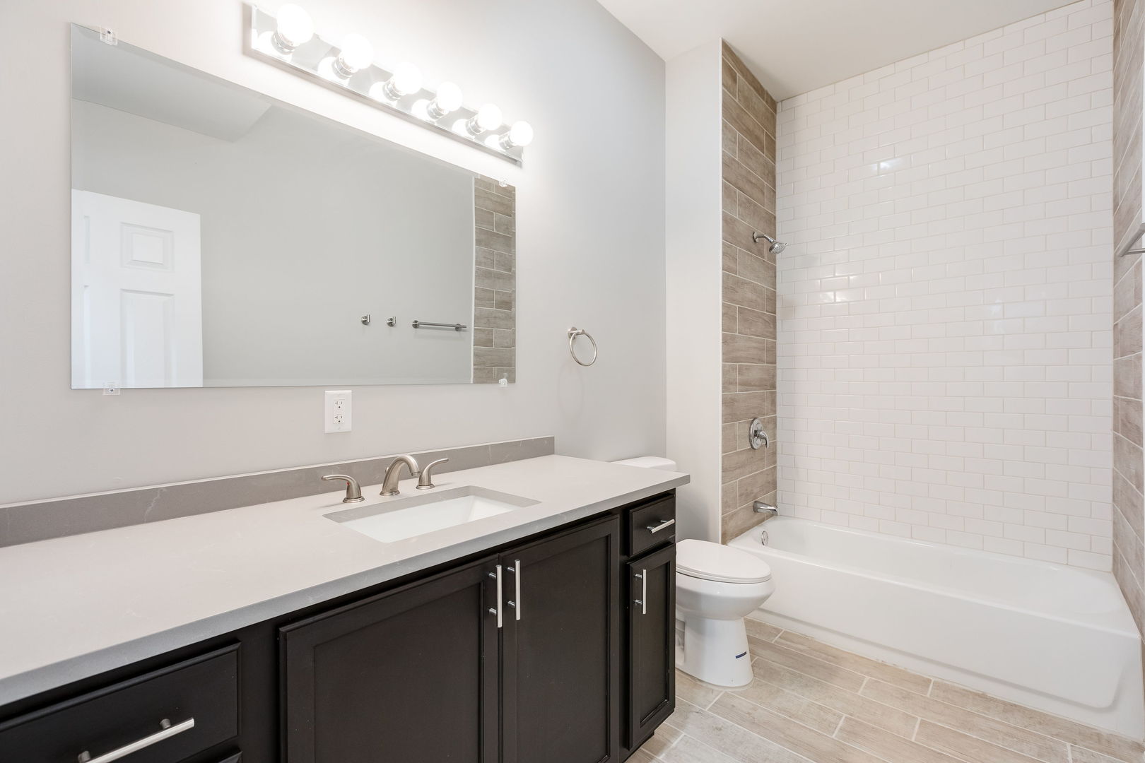 7753 South Morgan Street, Unit 3 Chicago, IL 60620 - Photo 10 of 13 a bathroom with a sink a toilet and a large mirror