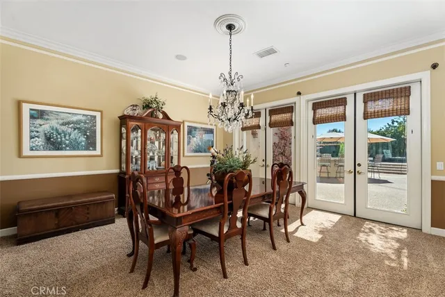 a kitchen with granite countertop lots of white cabinets a sink and appliances