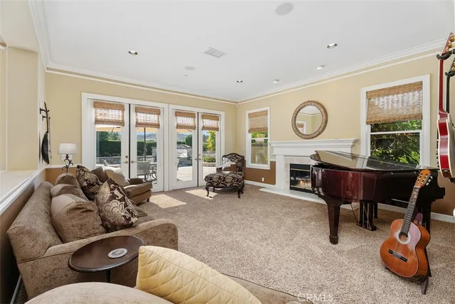 a kitchen with stainless steel appliances kitchen island granite countertop dining table chairs and white cabinets