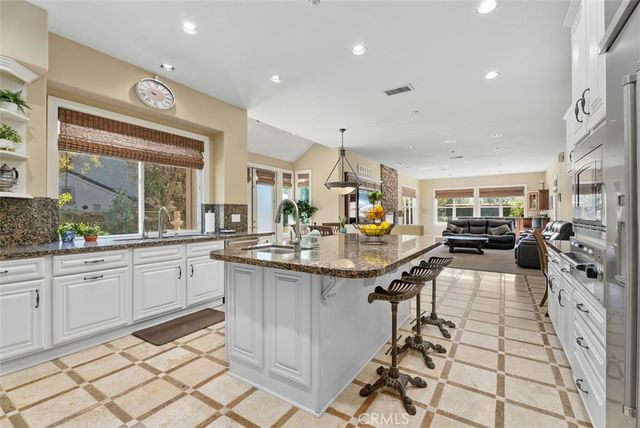 a living room with furniture kitchen view and a fireplace