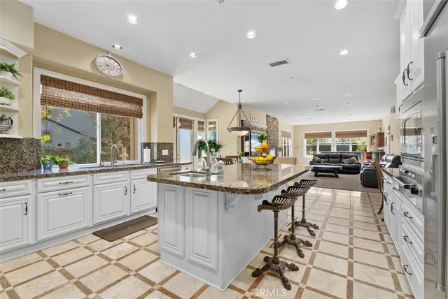 a living room with furniture kitchen view and a fireplace