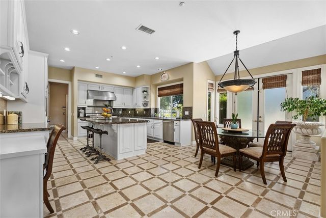 a view of a dining room with furniture wooden floor and a floor to ceiling window