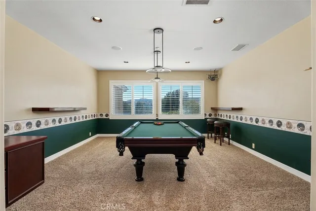a spacious bedroom with a bed and a chandelier