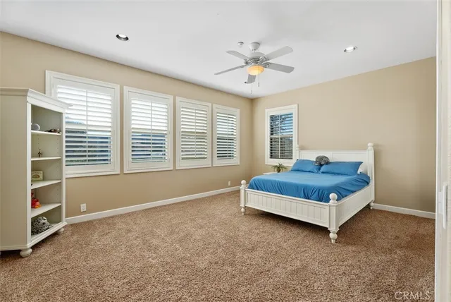 a spacious bathroom with a tub sink and mirror