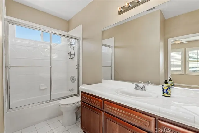 a spacious bathroom with a tub sink and mirror