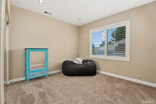 a view of a chair and tables in the balcony