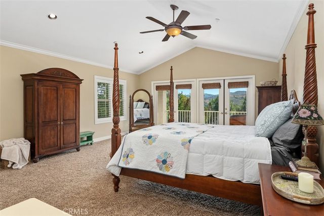 a view of a patio with chairs and a table under an umbrella