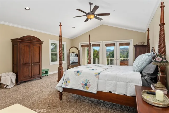 a view of a patio with chairs and a table under an umbrella