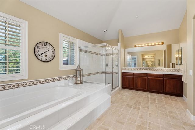 a aerial view of a house with a garden and lake view