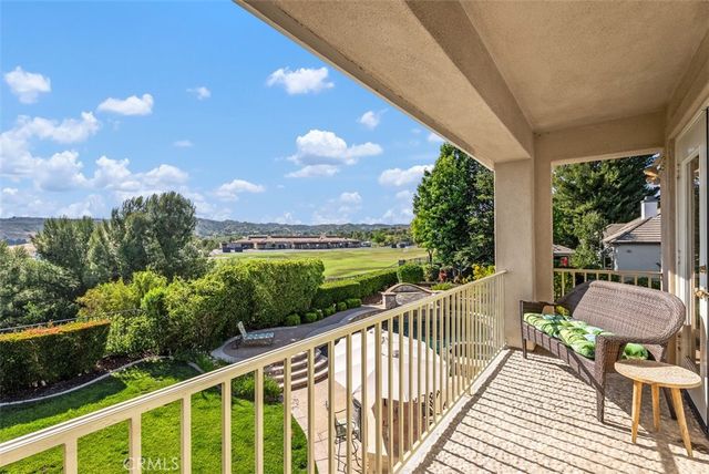 an aerial view of residential houses with outdoor space and ocean view