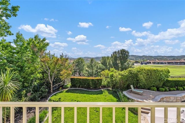 an aerial view of a house with garden space and a patio