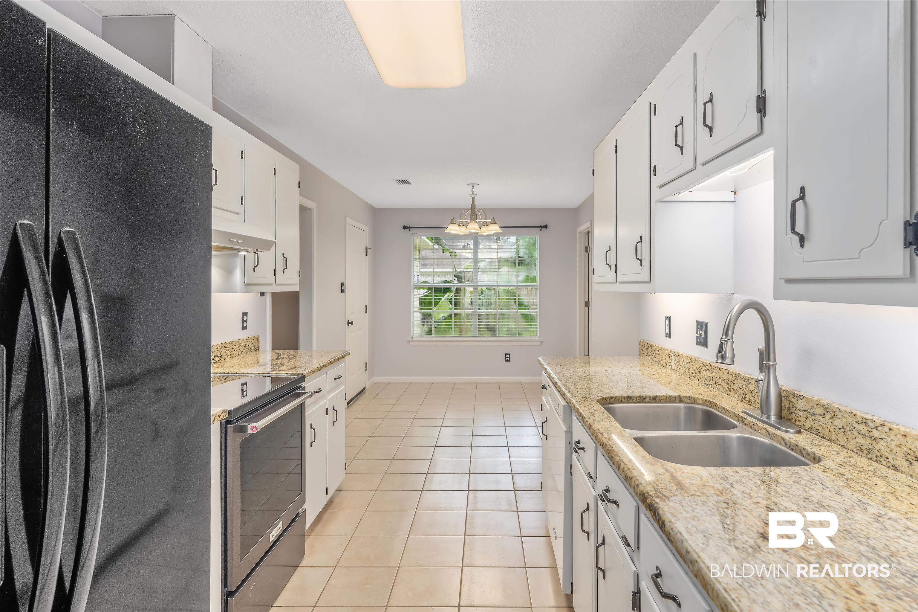25779 Austin Road Daphne, AL 36526 - Photo 21 of 30 Kitchen featuring freestanding refrigerator, stainless steel electric range, a sink, white cabinetry, and under cabinet range hood